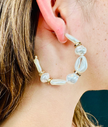 Lightweight boho earrings featuring cream cowrie shells