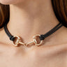 Model wearing the black double-strand rope necklace with polished gold horsebit toggle clasp
