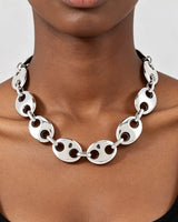 Model wearing the silver oval cut out link statement necklace