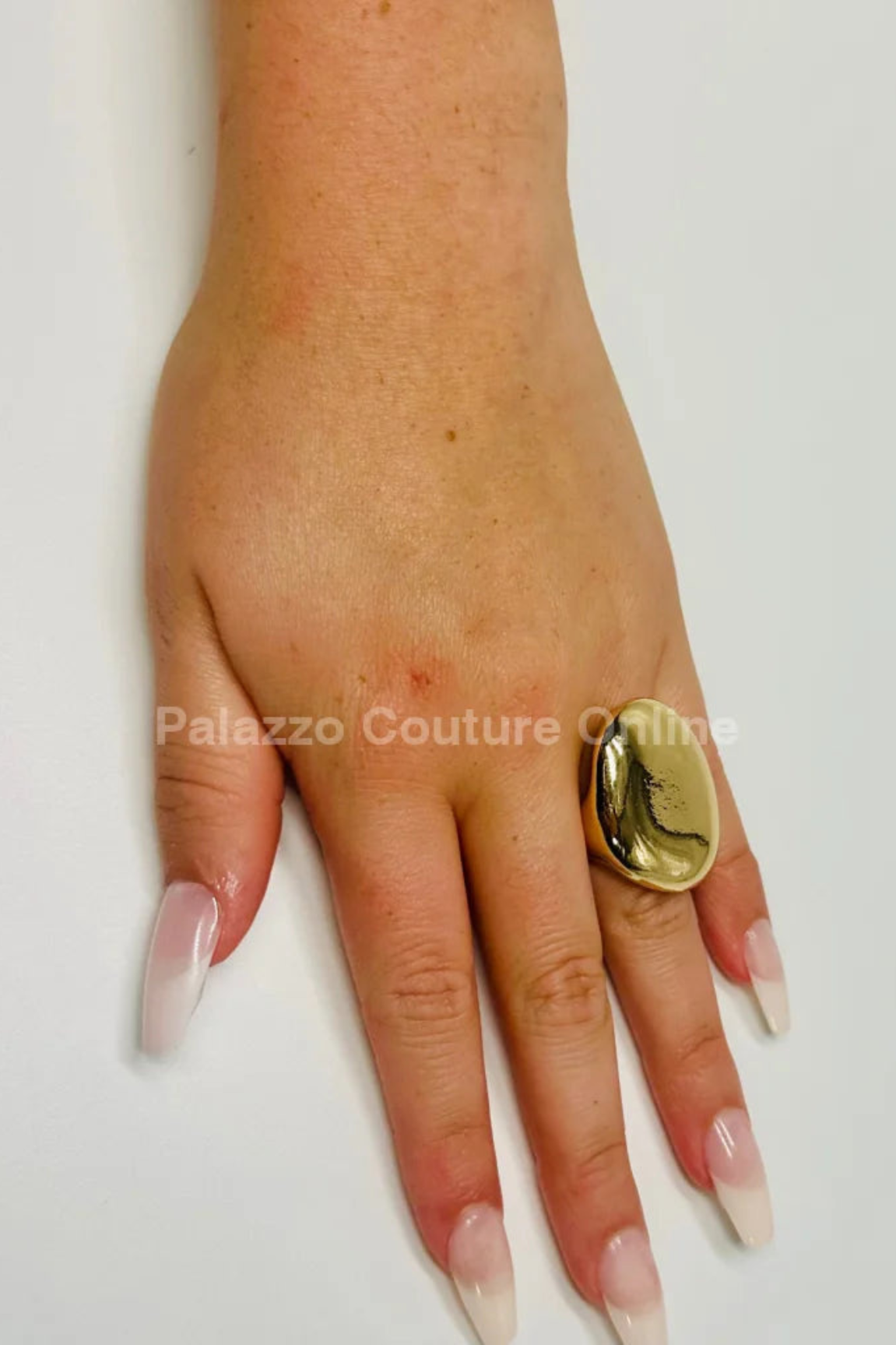 gold statement ring with a bold, smooth design