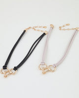 Polished horseshoe wrap rope necklace shown in both cord colors