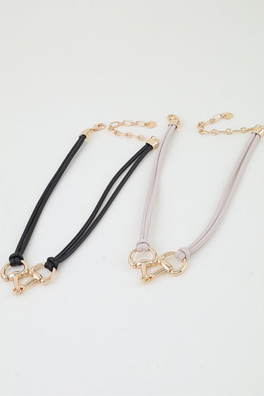 Polished horseshoe wrap rope necklace shown in both cord colors