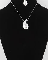Silver teardrop necklace and earring set on display bust