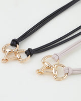 Close-up of the polished horsebit toggle clasp and knotted rope detail