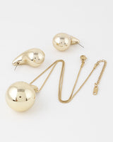 Gold teardrop necklace set: pendant necklace and matching earrings, flat lay