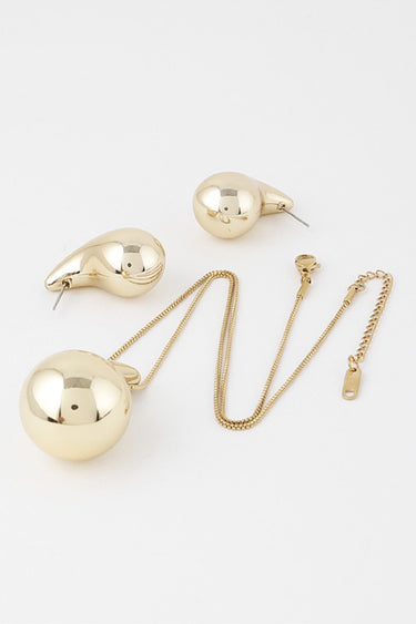 Gold teardrop necklace set: pendant necklace and matching earrings, flat lay