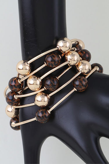 Leopard and gold bead bangle set worn stacked on a display hand