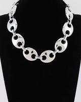 Silver oval link statement necklace on display bust