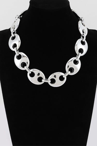 Silver oval link statement necklace on display bust
