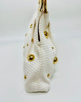 Elegant white handbag with circular handle and structured design