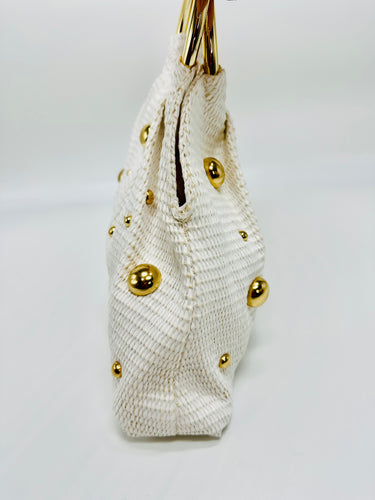 Elegant white handbag with circular handle and structured design