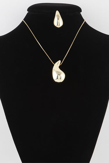 Gold teardrop necklace and earring set on display bust