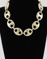 Gold oval link statement necklace on display bust