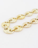Gold oval cut out links, close-up detail