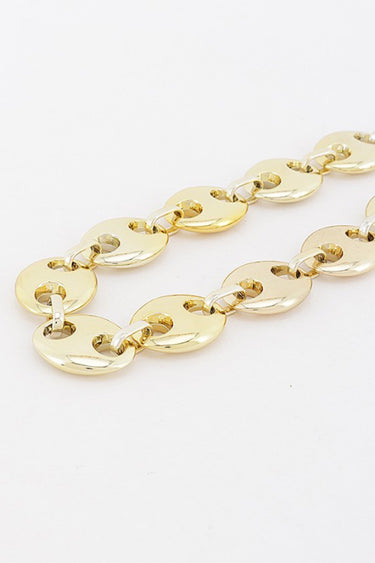 Gold oval cut out links, close-up detail