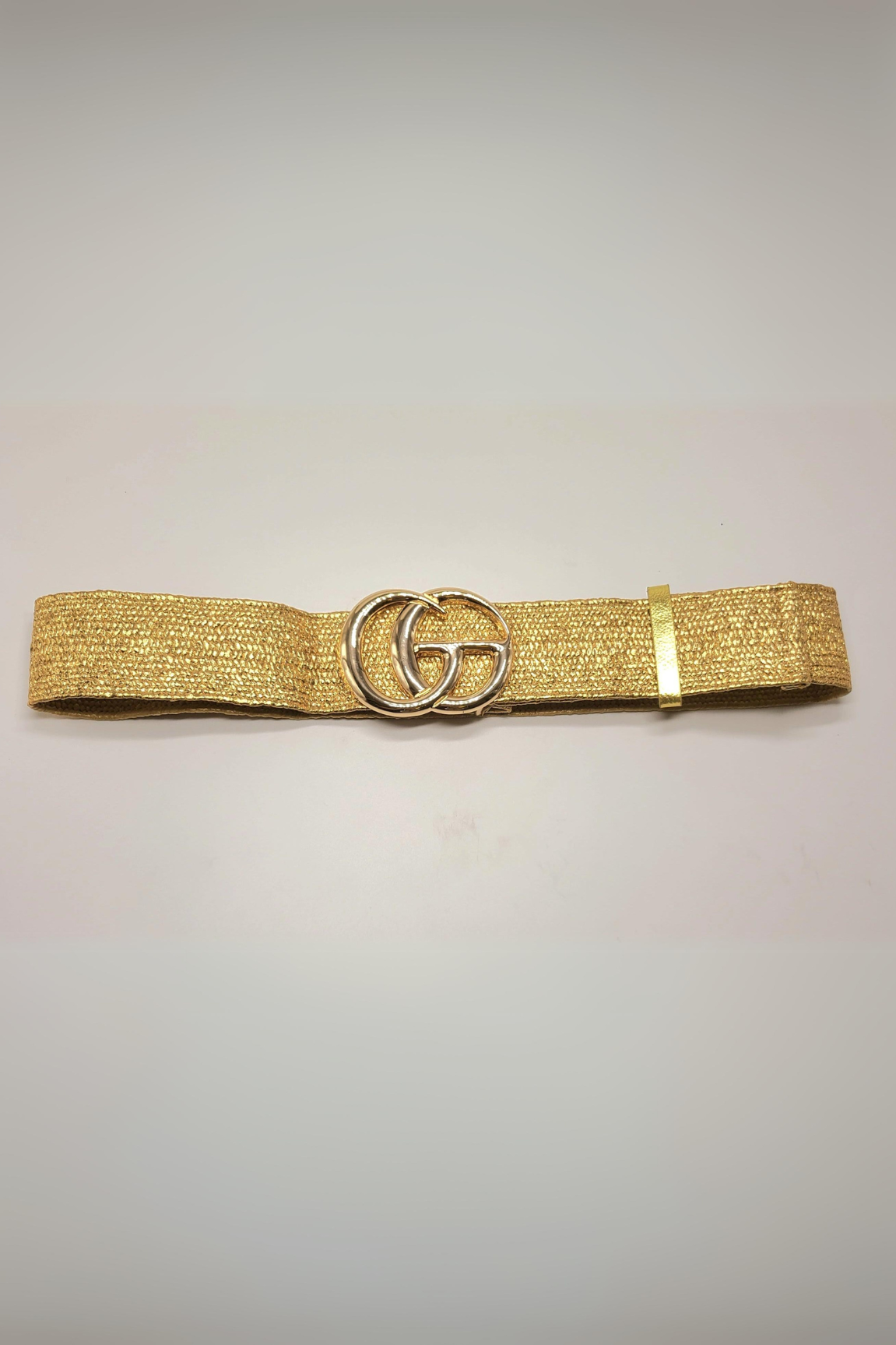 Shimmering metallic gold belt featuring a sleek and adjustable fit.