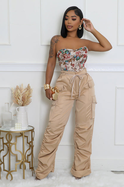 Beige cargo pants with a sleek high-waist design and side pockets, adding a touch of elegance to any wardrobe.