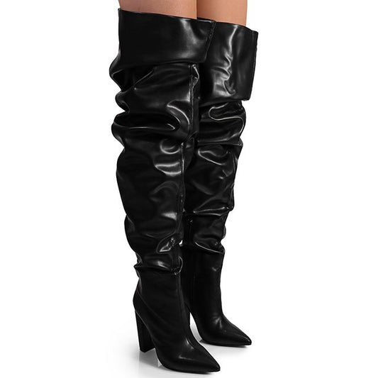 Black leather thigh-high boots with slouchy material, a sleek pointed toe, and comfortable block heels.