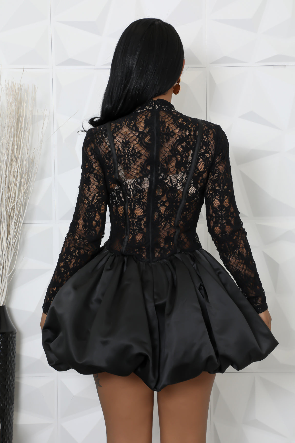 Black long sleeve lace dress with a voluminous balloon skirt silhouette.
