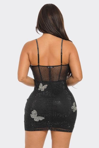 A breathtaking black dress adorned with rhinestone butterflies and intricate sheer detailing that creates an elegant, evening-ready look.