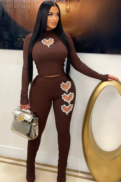 Stylish brown two-piece ribbed set including high-waisted leggings with crystal heart designs and a coordinating fitted top with rhinestones.
