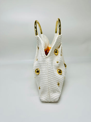 Minimalist white woven tote with golden accent spheres