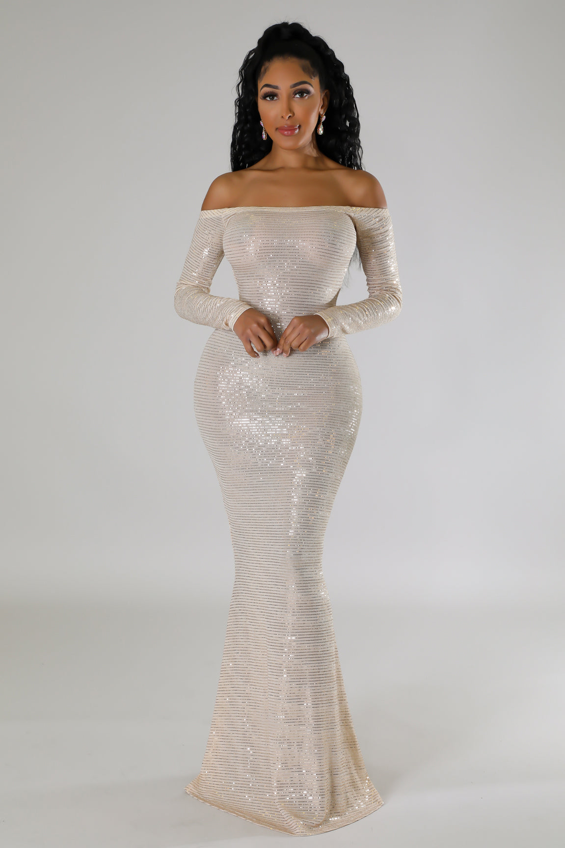 A dazzling champagne off-shoulder evening dress with sparkling sequins and long sleeves, perfect for formal occasions.