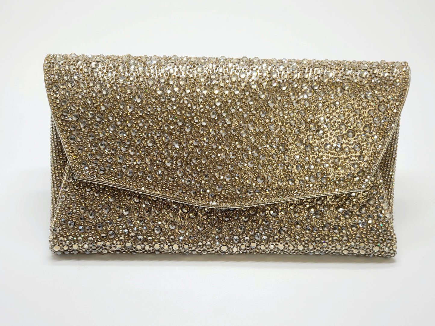 Shimmering gold evening bag with an envelope-style design and sparkling crystals.
