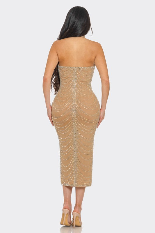 Nude mesh halter dress with all-over crystal embellishments, designed for a glamorous evening out.