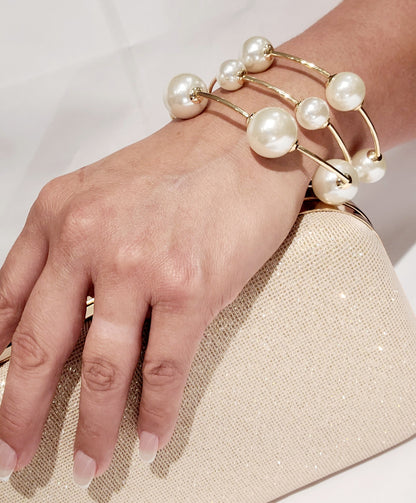 Gold cuff bracelet with large and small pearls for a modern look.