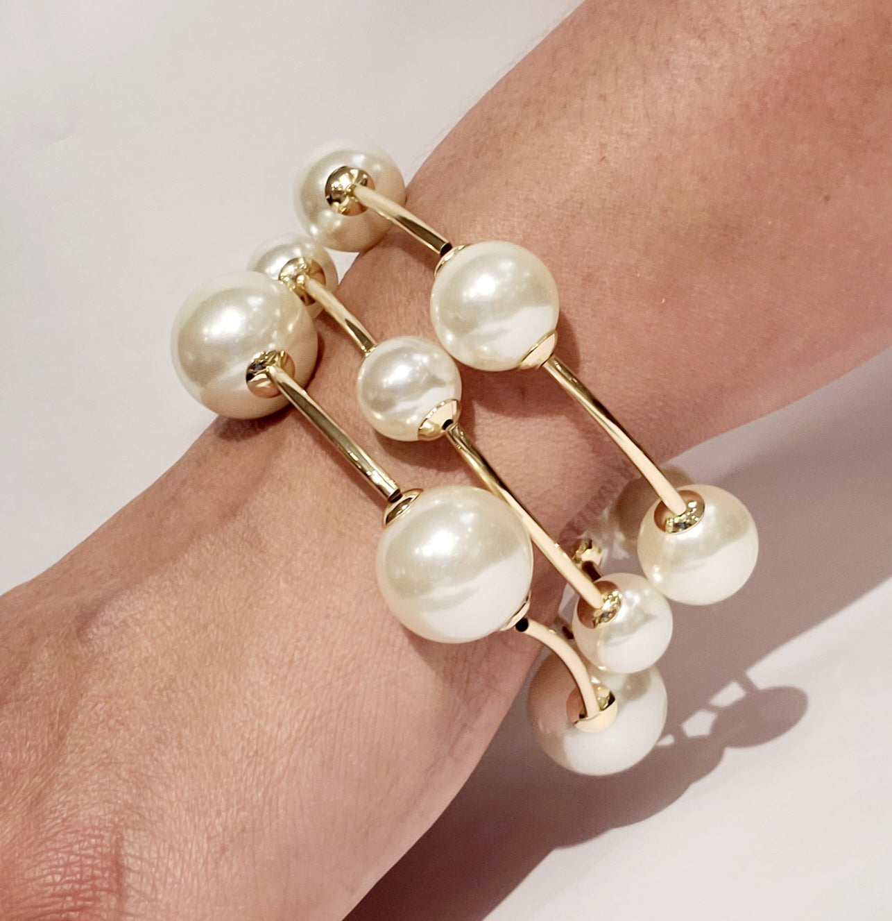 Elegant pearl cuff bracelet in gold, perfect for special occasions.