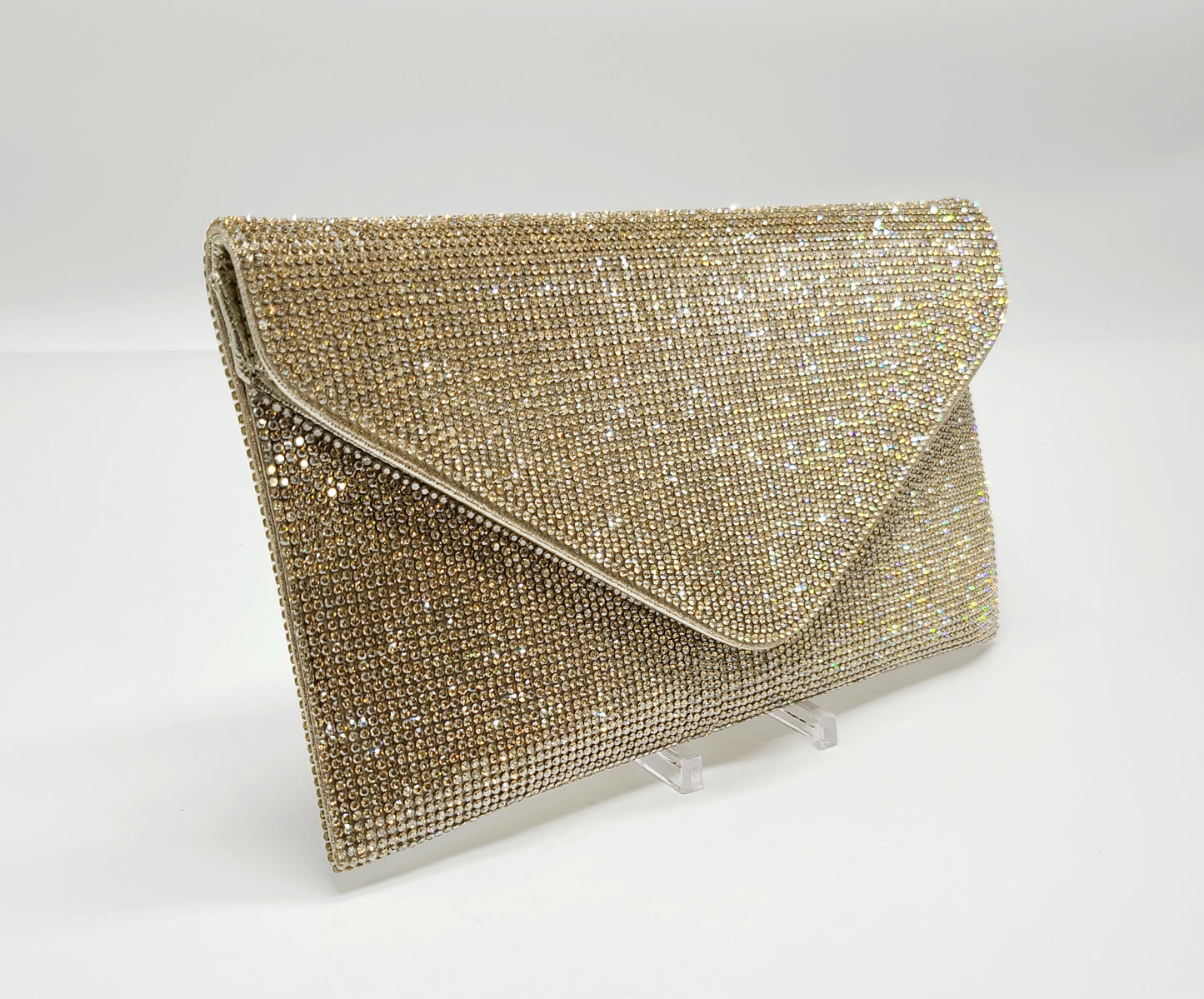 Elegant gold evening clutch shimmering with crystal rhinestones.
