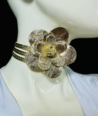 Gold leather wrap belt with floral centerpiece