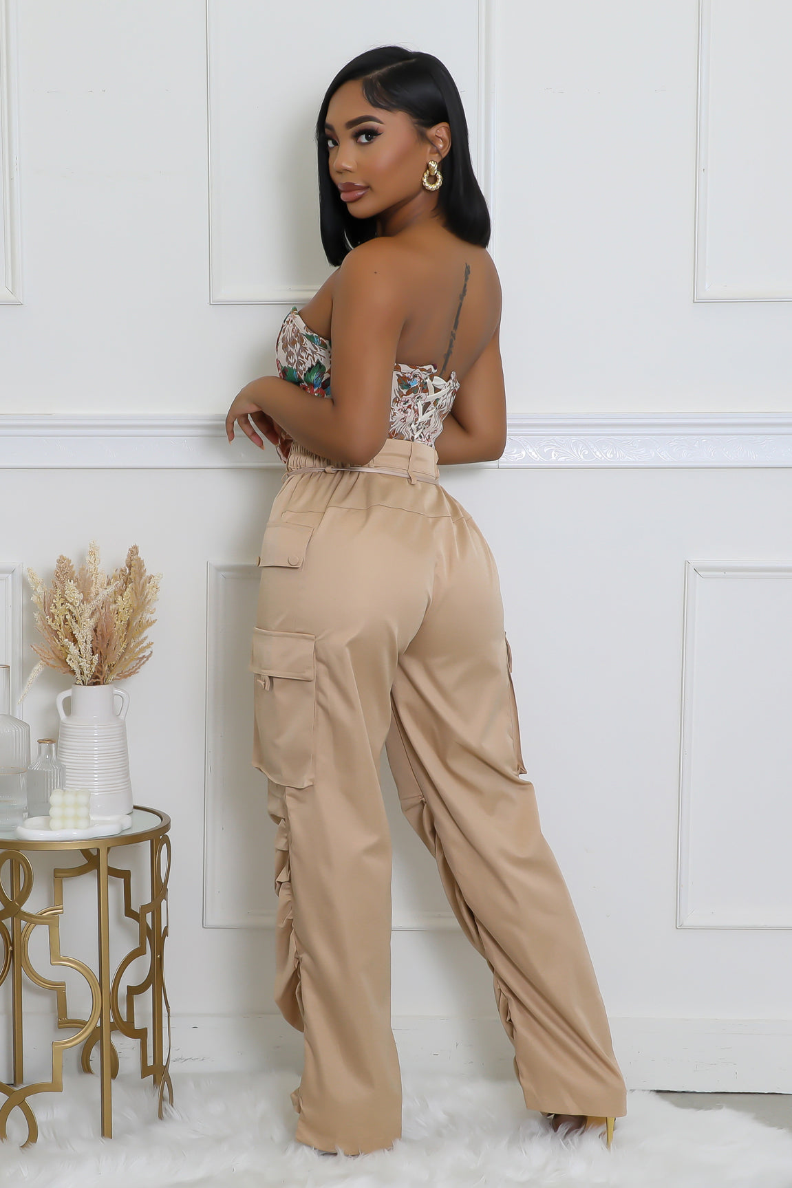 Trendy beige cargo pants featuring utility pockets and a flattering fit, designed for a modern and comfortable style.