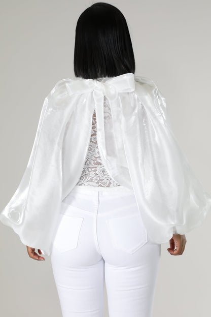 Modern white lace blouse with organza sleeves and white jeans