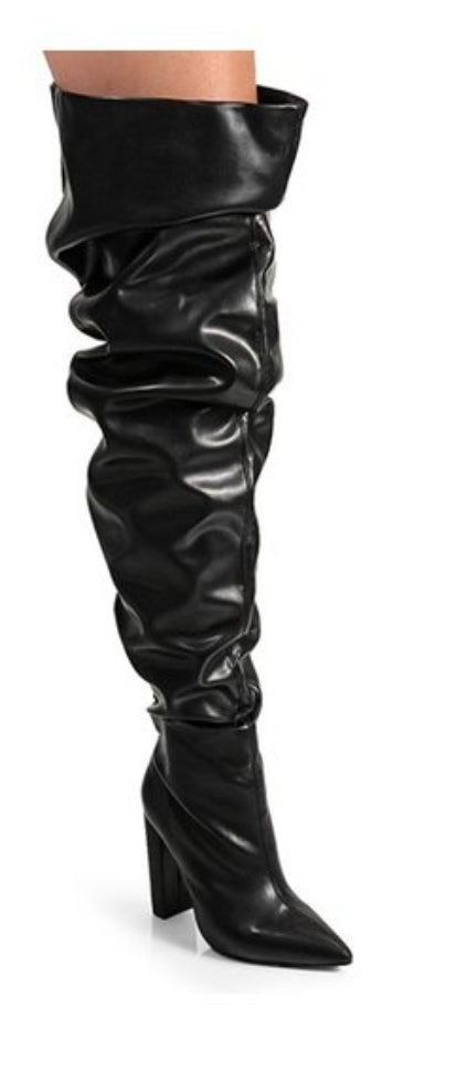 Black thigh-high boots with slouchy leather material and block heels, perfect for chic and casual winter outfits.