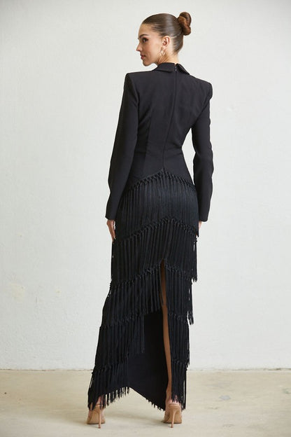 back view of a long black dress with fringe detail on the skirt.