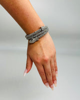 Close-up of silver serpentine wrap bracelet showing intricate texture