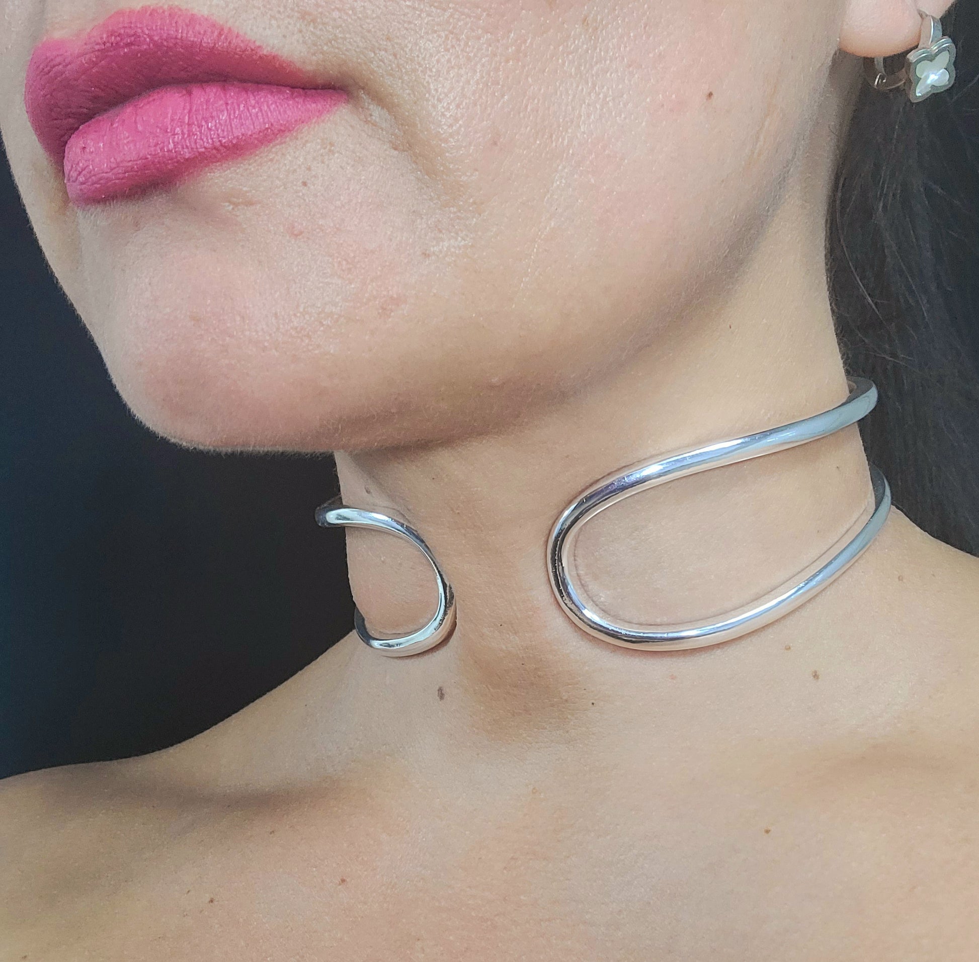 Polished silver choker with a modern open-end design, perfect for women.