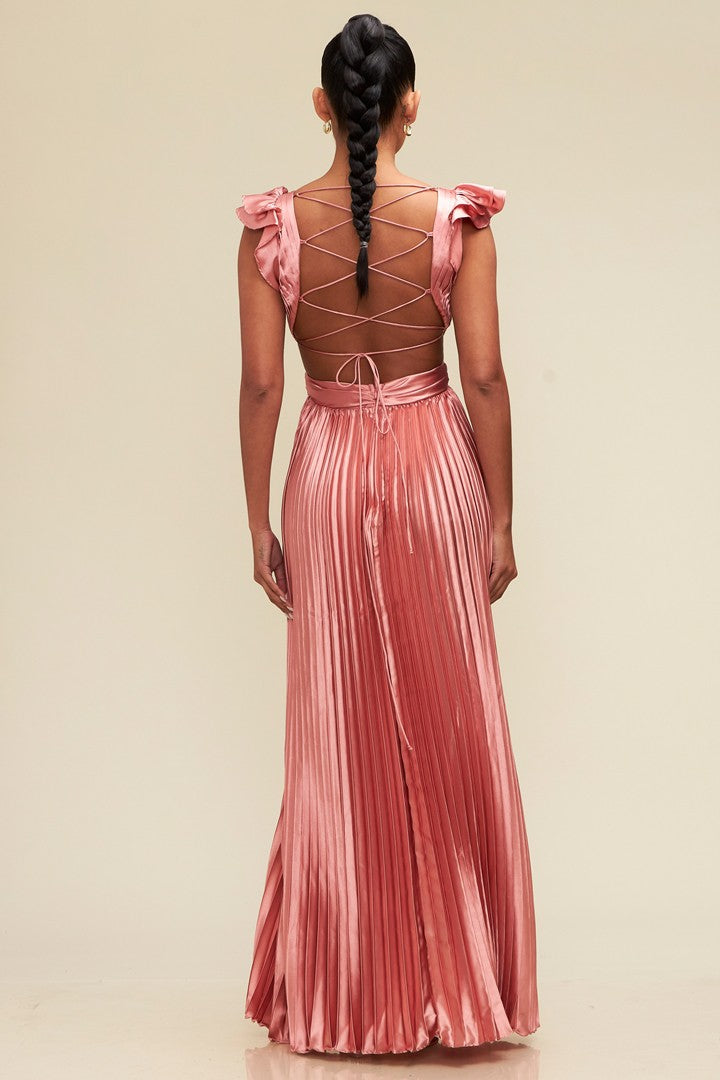 Pink pleated satin gown with a deep V-neckline, ruffled shoulders, and an adjustable lace-up back, creating a sleek silhouette.