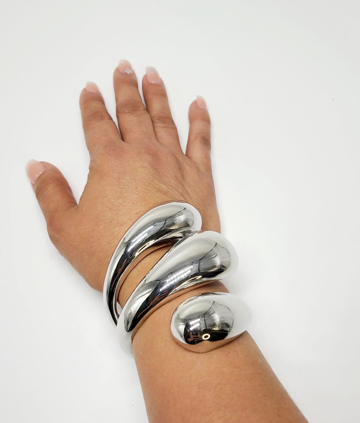 Elegant silver bangle bracelet with a modern, sculptural design
