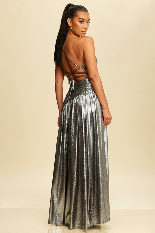 Metallic silver evening gown with a one-shoulder design, featuring a cut-out and wrap detail at the waist.
