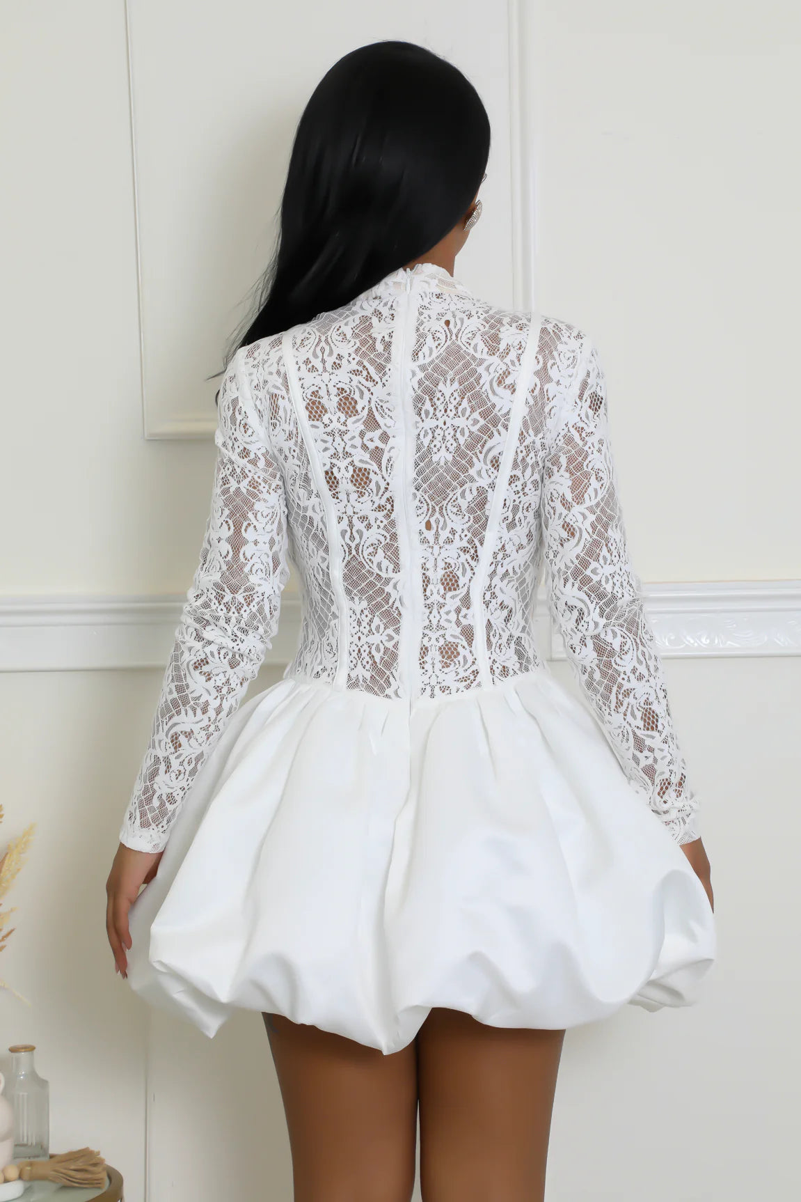 White lace balloon dress with intricate floral detailing and puff skirt.
