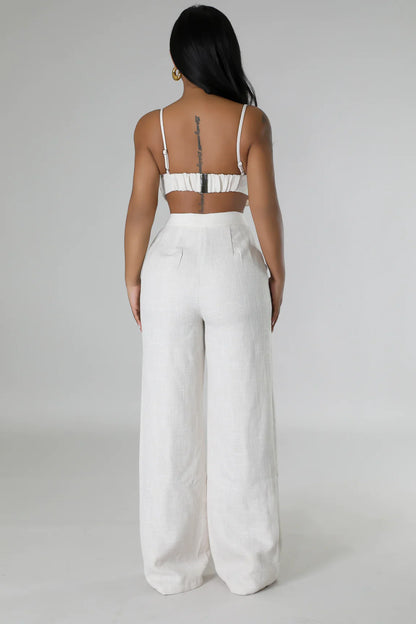 High-waist wide-leg linen pants with floral top, part of the Sahara Flowers summer collection.