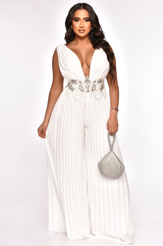 Detailed shot of a white jumpsuit with wide legs and embellished waist