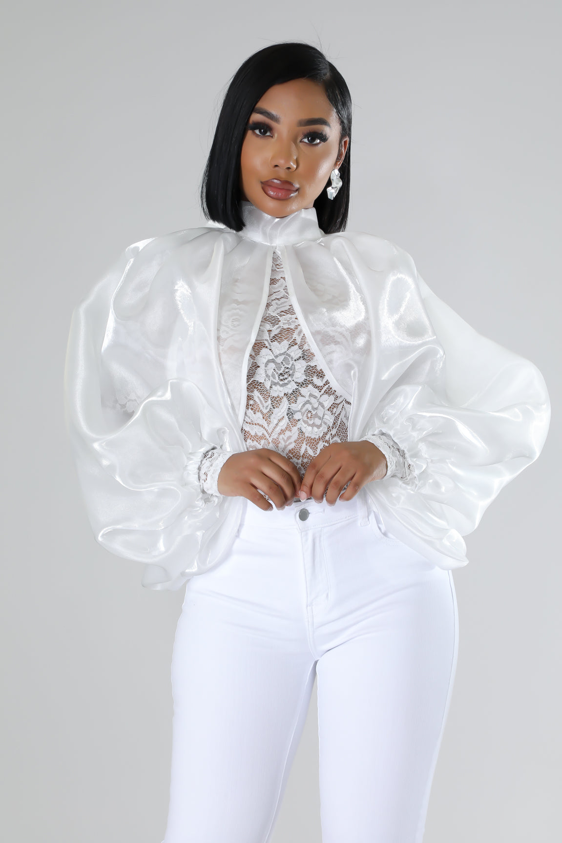 Intricate lace blouse with organza sleeves and white jeans