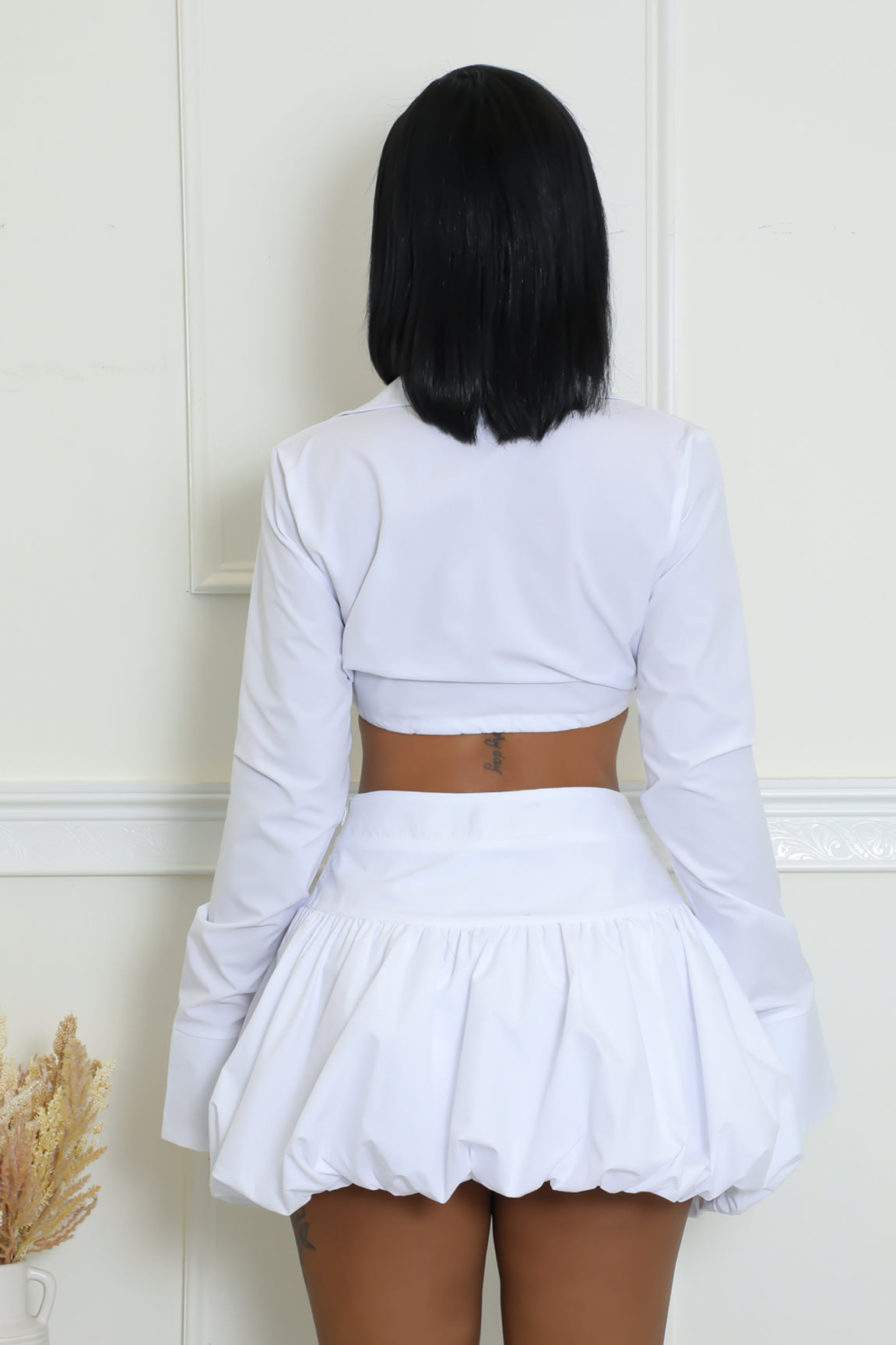 Stylish balloon skirt set in white with long-sleeved crop top.
