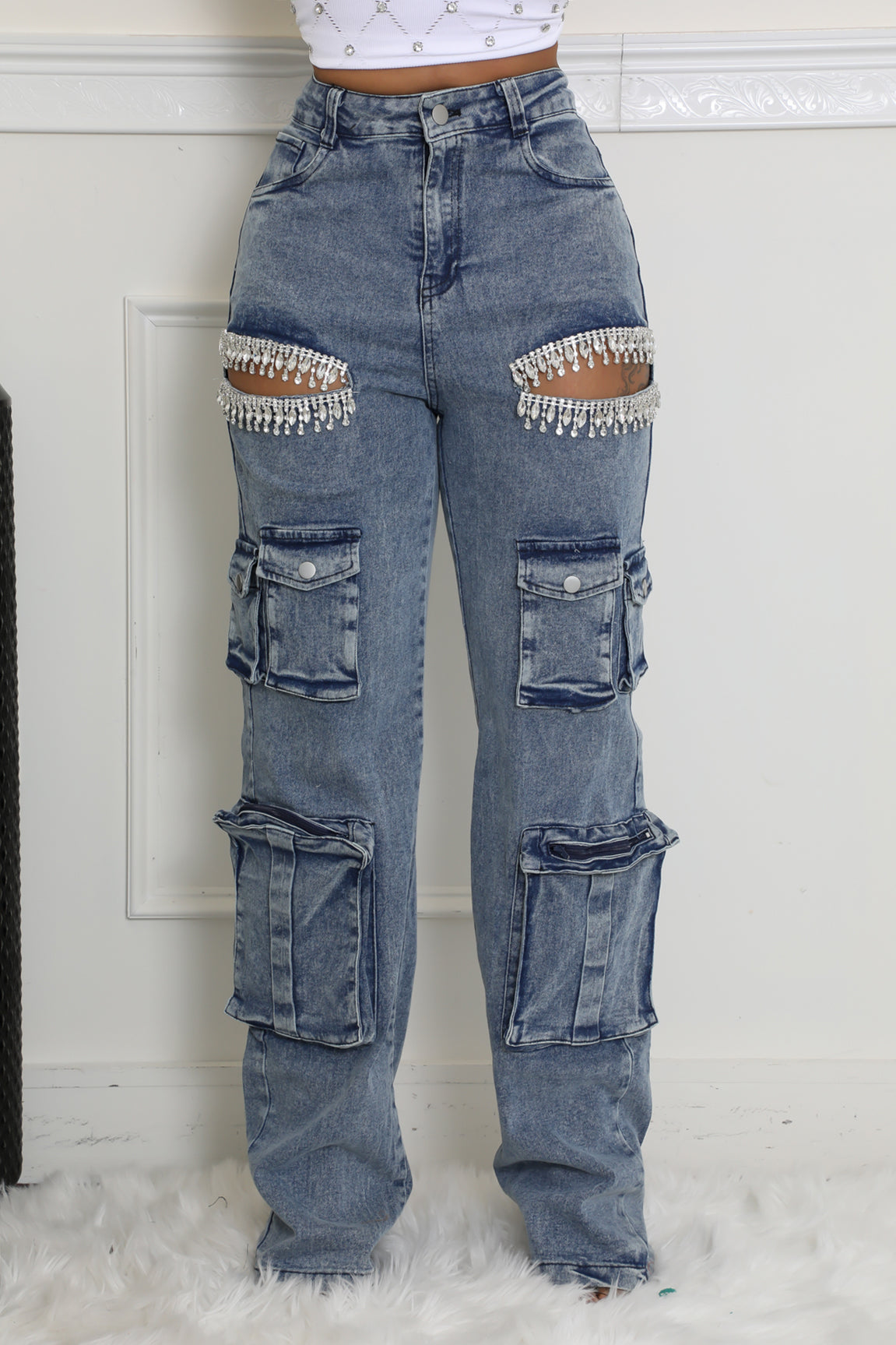 Trendy high-waisted denim cargo pants with intricate rhinestone accents and functional pocket designs for a bold and chic look.