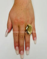 Close‑up of gold statement ring showing gloss and detail