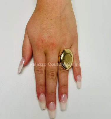 Close‑up of gold statement ring showing gloss and detail